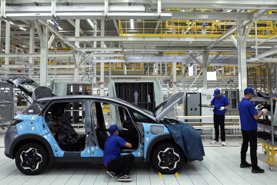 Công nhân lắp ráp một chiếc ô tô điện bên trong nhà máy xe điện (EV) đầu tiên của BYD ở Đông Nam Á. Ảnh: Reuters.